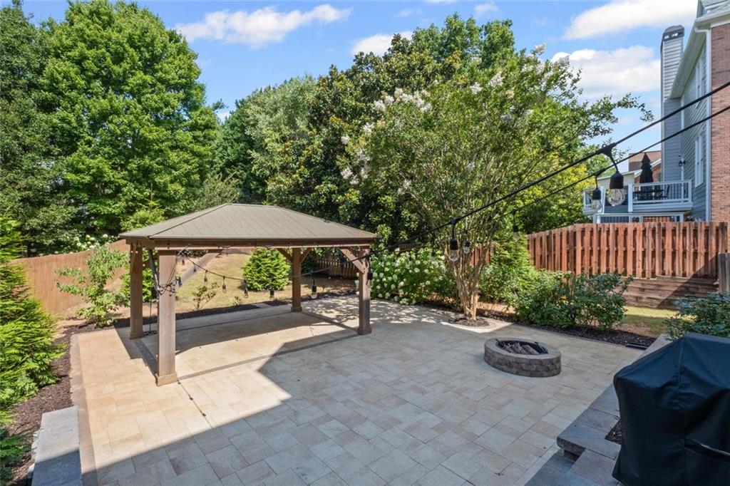 12857 Waterside Drive Alpharetta, GA 30004 - Photo 43 of 60 a view of a patio with a table and chairs under an umbrella