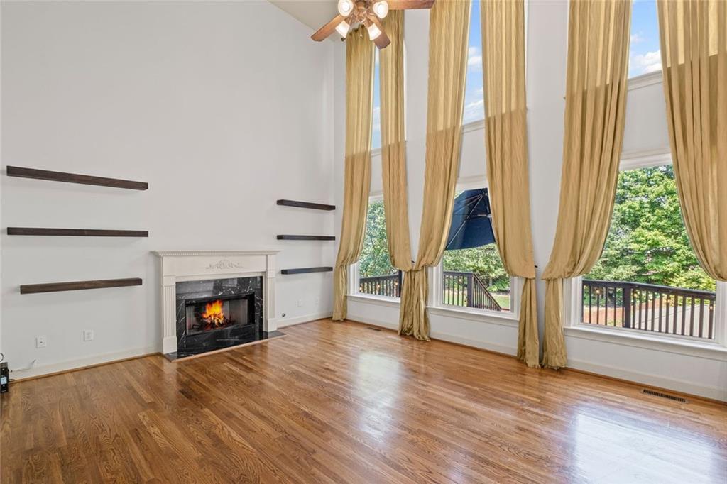 12857 Waterside Drive Alpharetta, GA 30004 - Photo 10 of 60 a view of an empty room with a fireplace and a window