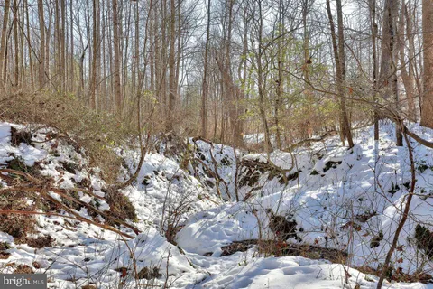 a view of a road with wooden fence