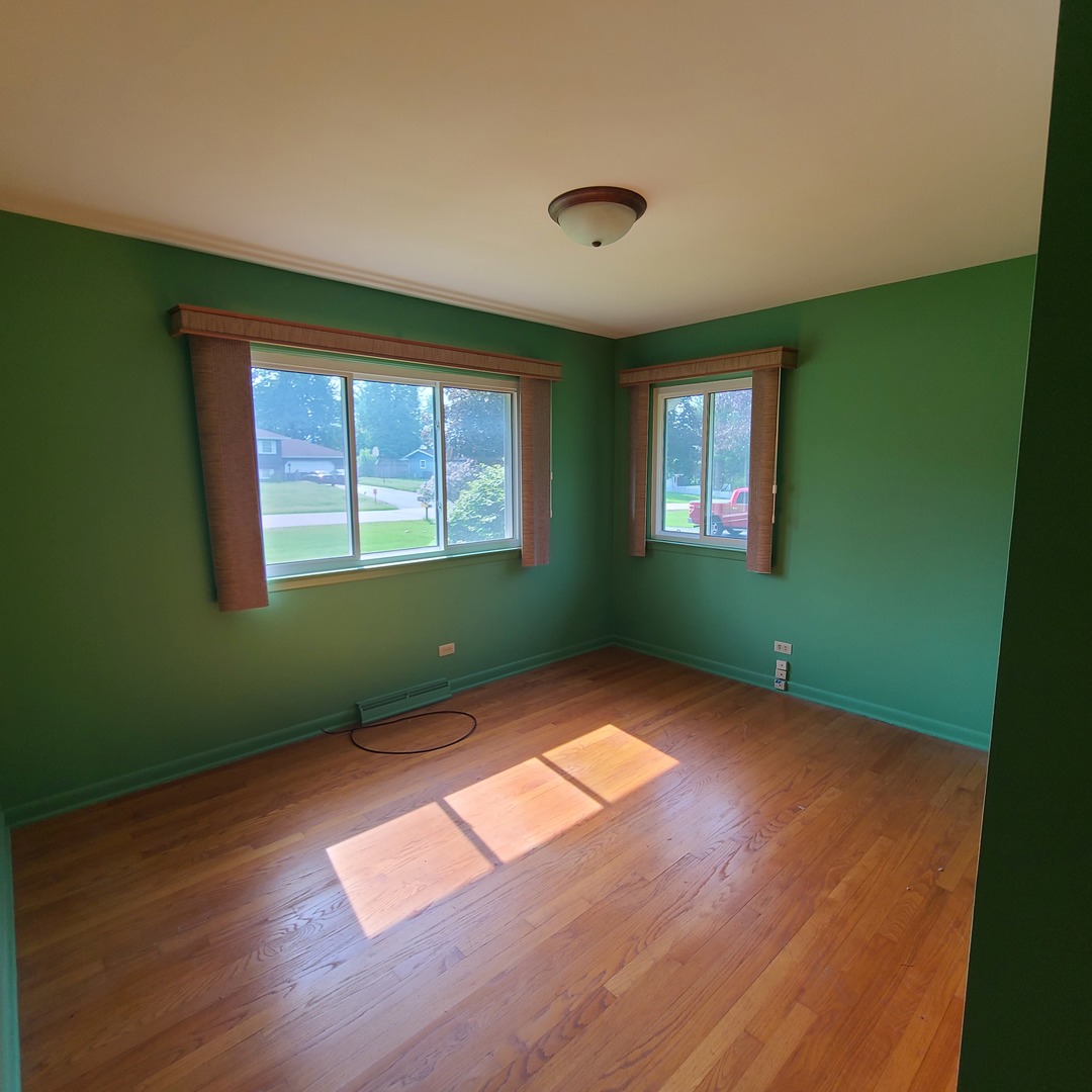 12N238 Hilltop Road Elgin, IL 60124 - Photo 14 of 21 a view of an empty room with wooden floor and a window