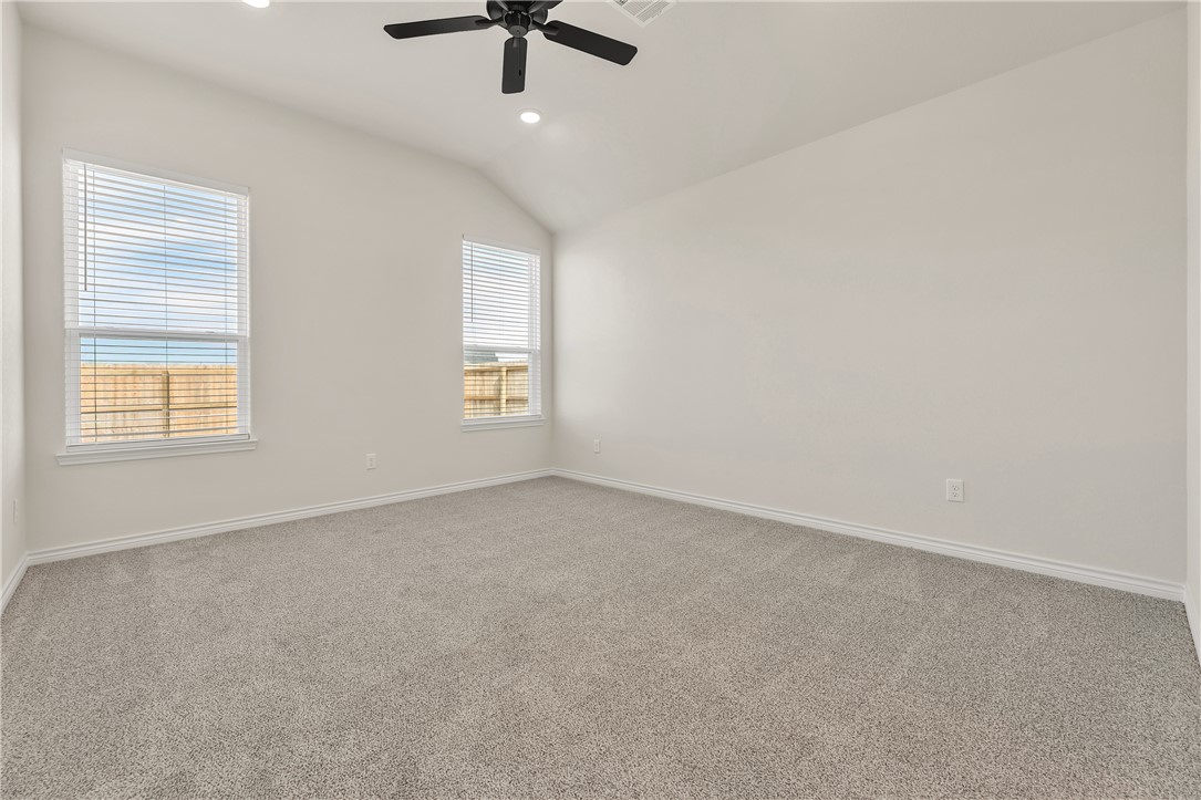 7804 Redbud Road Navasota, TX 77868 - Photo 11 of 26 an empty room with a window and a ceiling fan