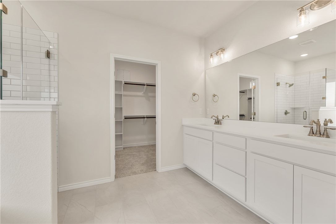 7804 Redbud Road Navasota, TX 77868 - Photo 13 of 26 a bathroom with double sink and a mirror