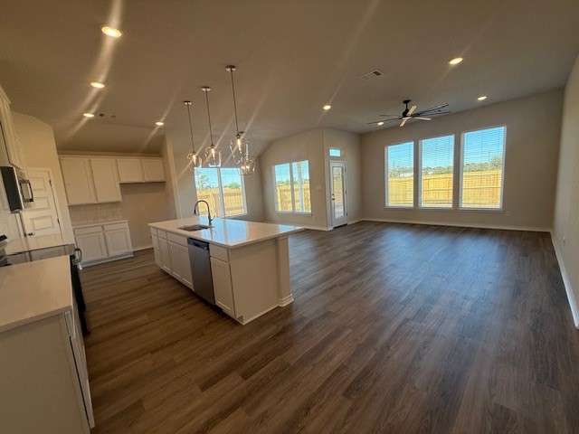 7804 Redbud Road Navasota, TX 77868 - Photo 25 of 25 a large kitchen with stainless steel appliances granite countertop a large counter top a wooden floors and a large window