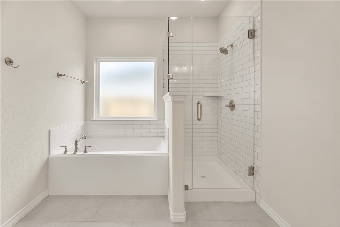 7804 Redbud Road Navasota, TX 77868 - Photo 14 of 26 a bathroom with a bathtub and a shower