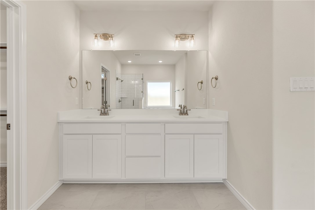 7804 Redbud Road Navasota, TX 77868 - Photo 16 of 26 a bathroom with a sink and a mirror