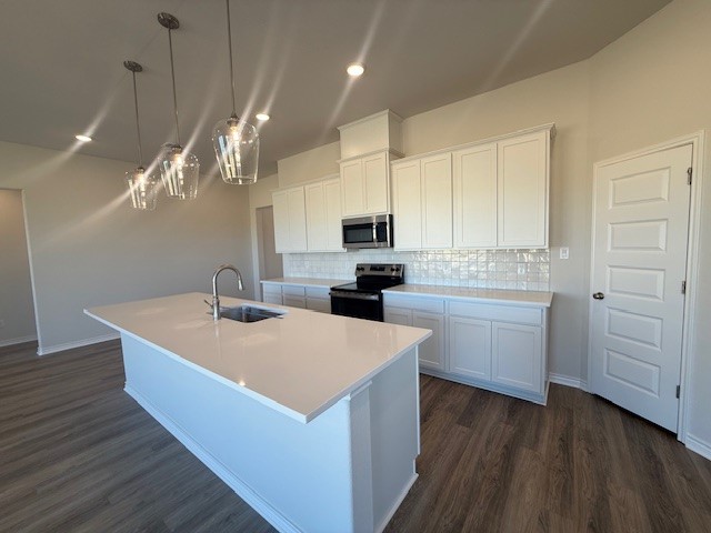 7804 Redbud Road Navasota, TX 77868 - Photo 17 of 25 a large kitchen with kitchen island a white counter space a sink and appliances