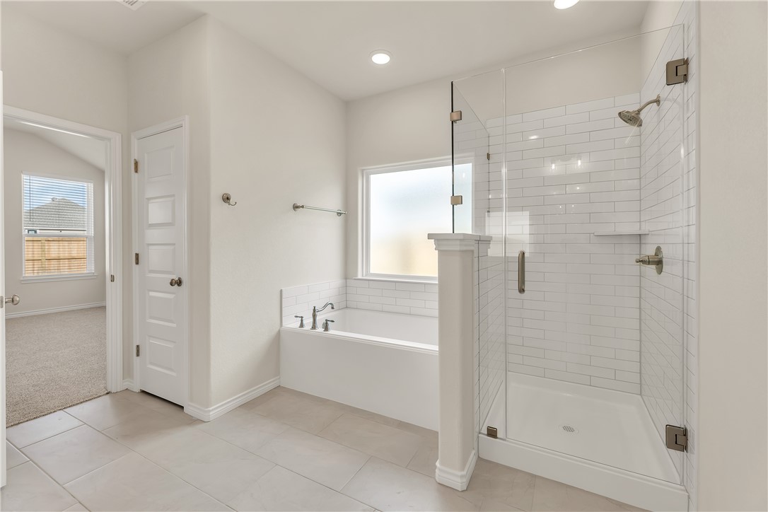 7804 Redbud Road Navasota, TX 77868 - Photo 18 of 26 a bathroom with a bathtub and a shower