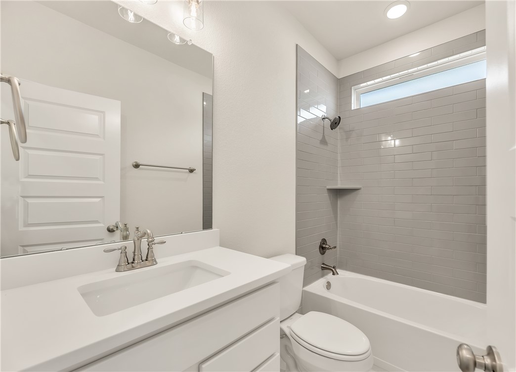 7804 Redbud Road Navasota, TX 77868 - Photo 23 of 26 a bathroom with a sink a toilet and a bathtub