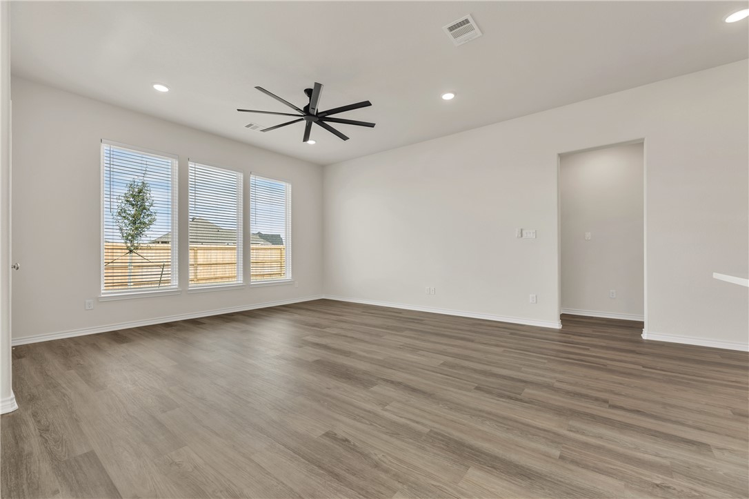 7804 Redbud Road Navasota, TX 77868 - Photo 5 of 26 a view of empty room with wooden floor and fan