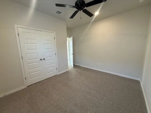 an empty room with closet area