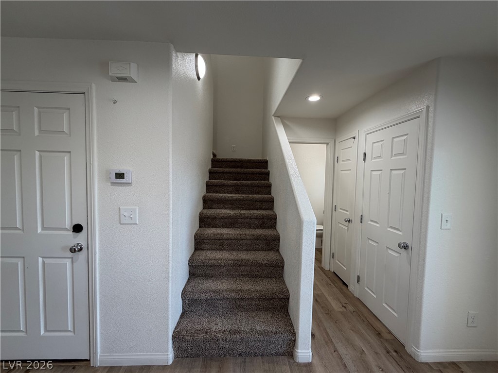 3610 Wireless Court Las Vegas, NV 89129 - Photo 5 of 15 A welcoming entryway with warm flooring leads to carpeted stairs, creating a pleasant transition between levels.