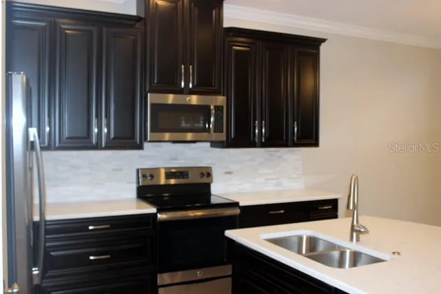 a kitchen with granite countertop a stove and a microwave