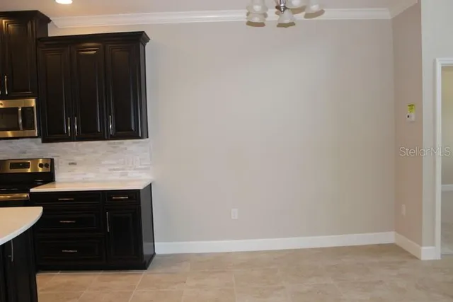 a view of a kitchen with a sink and cabinets