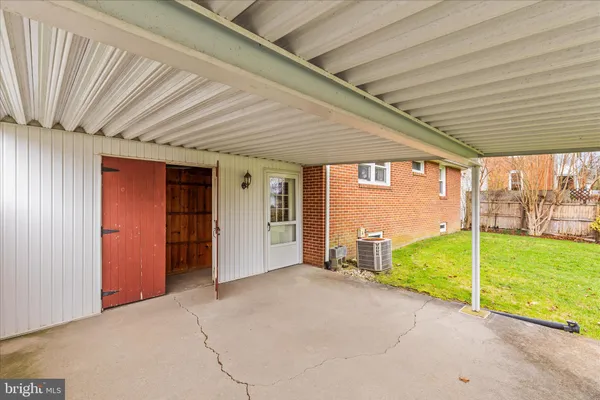 a view of a backyard with wooden fence