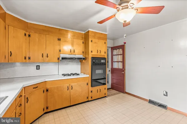 a kitchen with cabinets a sink and appliances