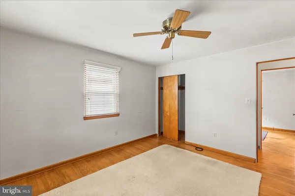 a view of room with a ceiling fan and window