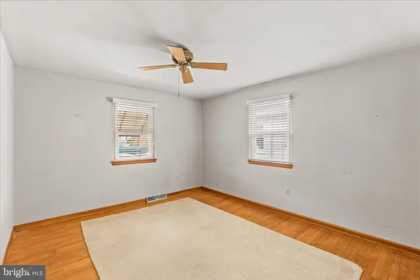 a view of a room with a wooden floor and window