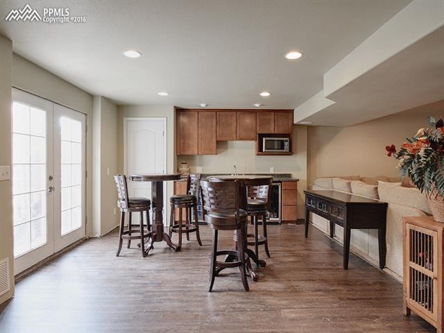 11350 Calgary Road Peyton, CO 80831 - Photo 20 of 29 Great wet bar complete with pantry, wine cooler, beer cooler, and microwave.
