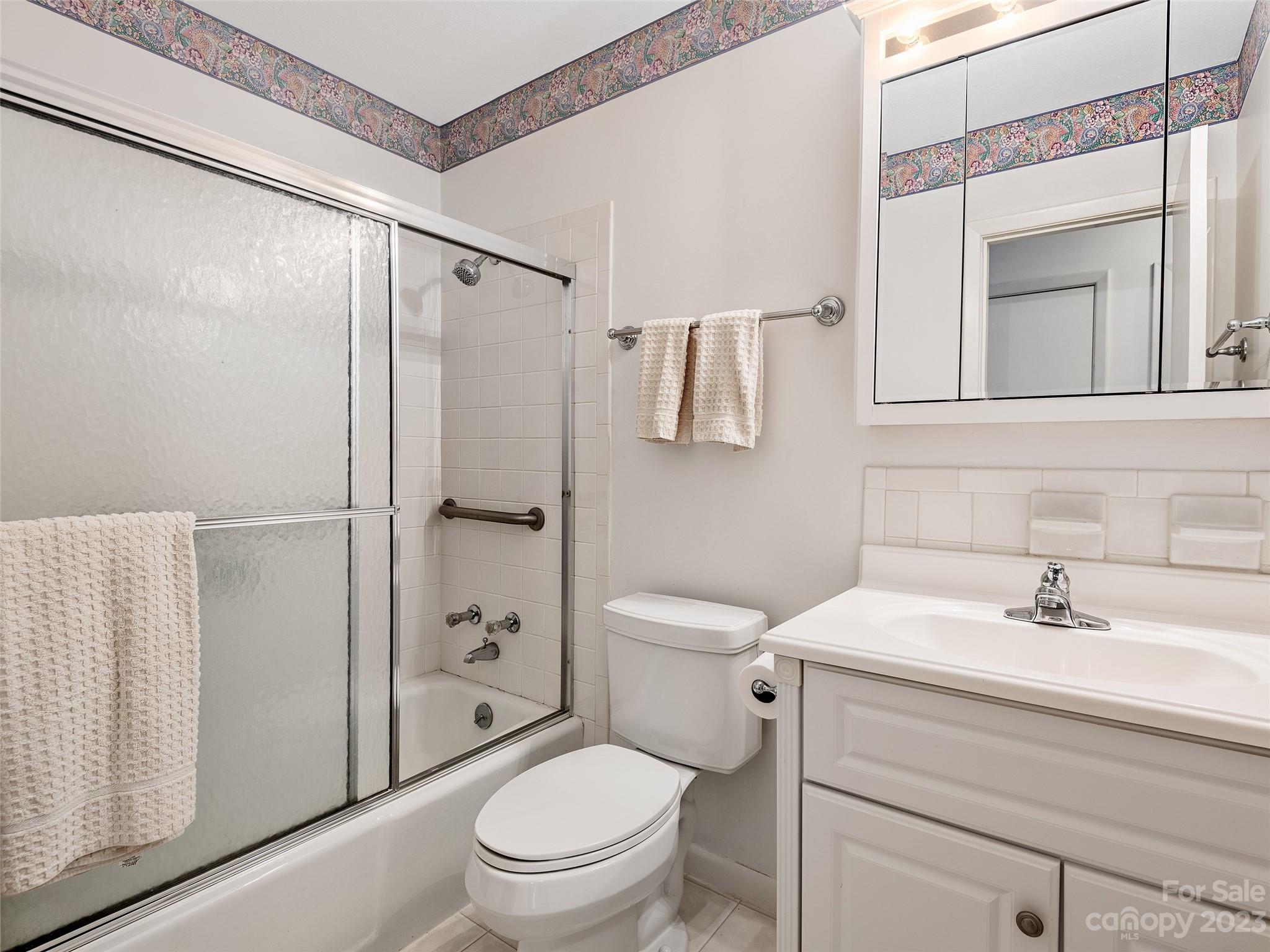 102 Boyd Drive, Unit 5B Flat Rock, NC 28731 - Photo 12 of 16 a bathroom with a sink toilet and shower