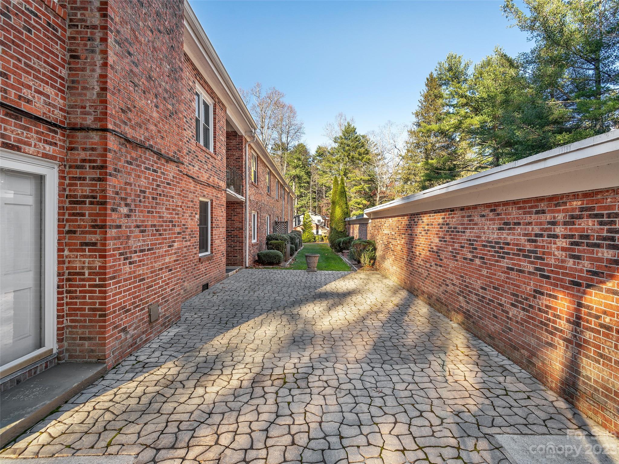 102 Boyd Drive, Unit 5B Flat Rock, NC 28731 - Photo 13 of 16 a view of a pathway with a house in the background