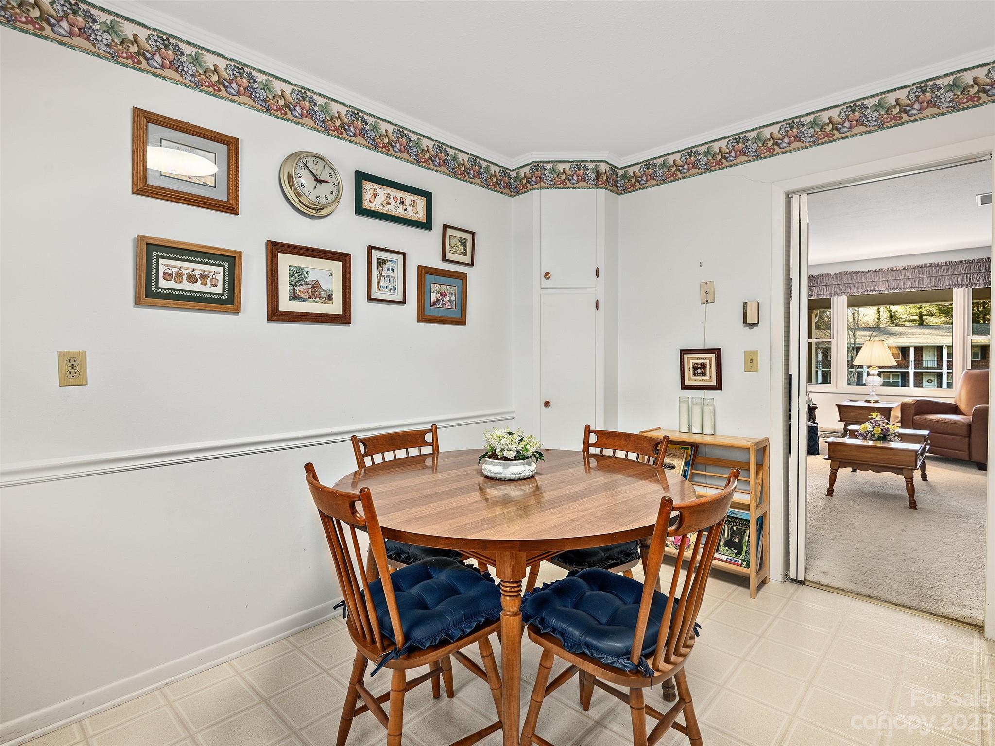102 Boyd Drive, Unit 5B Flat Rock, NC 28731 - Photo 5 of 16 a view of a dining room with furniture and a table chair