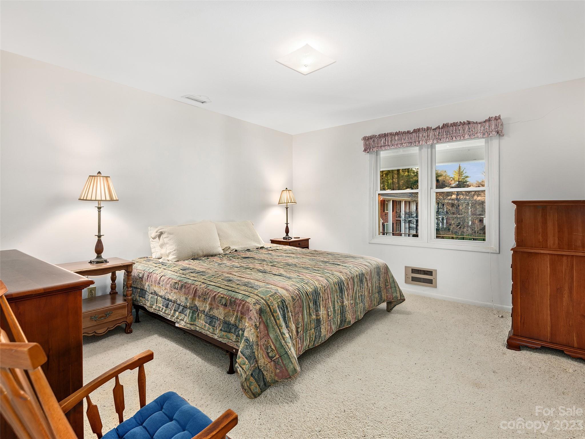 102 Boyd Drive, Unit 5B Flat Rock, NC 28731 - Photo 7 of 16 a bedroom with a bed window and wall painting