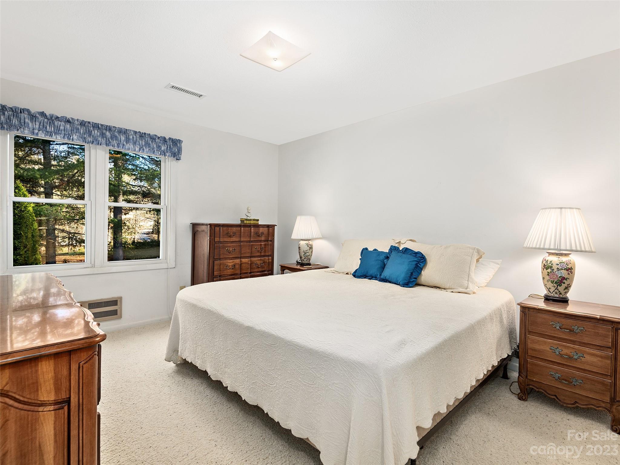 102 Boyd Drive, Unit 5B Flat Rock, NC 28731 - Photo 10 of 16 a spacious bedroom with a bed and a couch