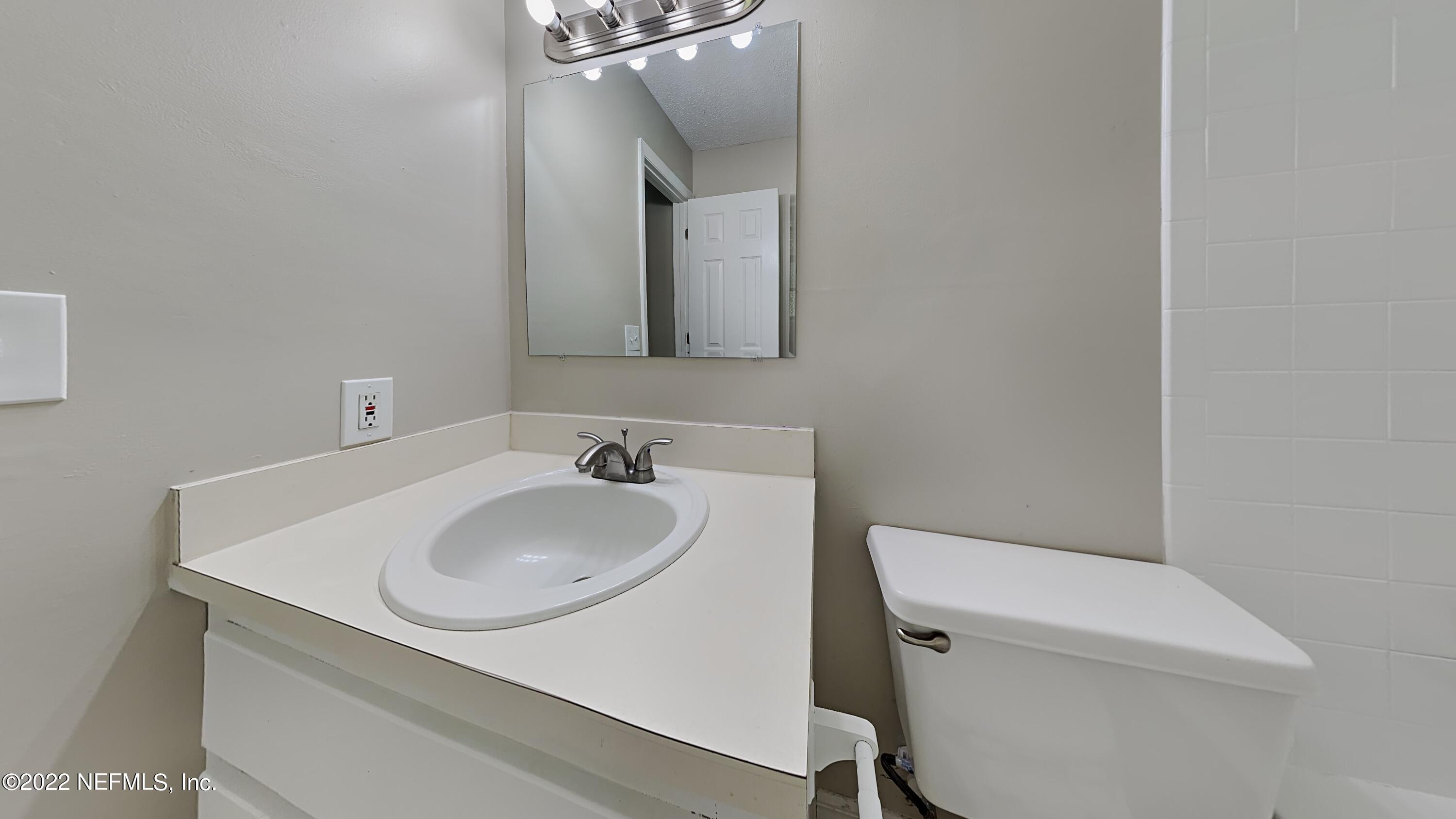54189 Vikki Road Callahan, FL 32011 - Photo 9 of 18 a bathroom with a toilet sink and mirror