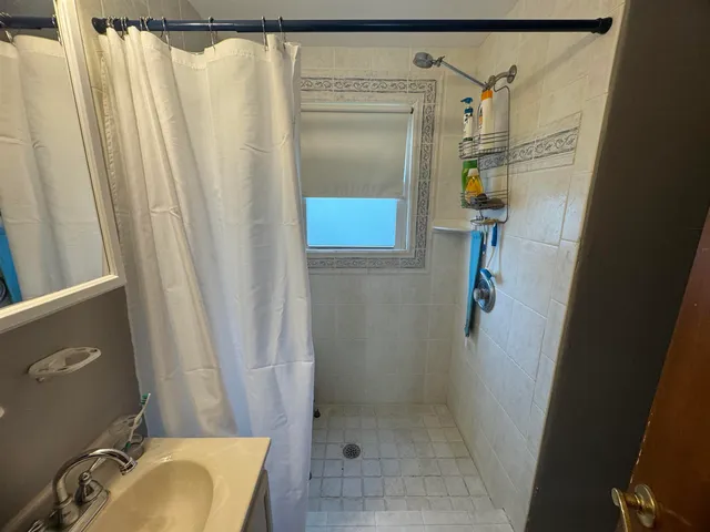a bathroom with a tub and a shower curtain