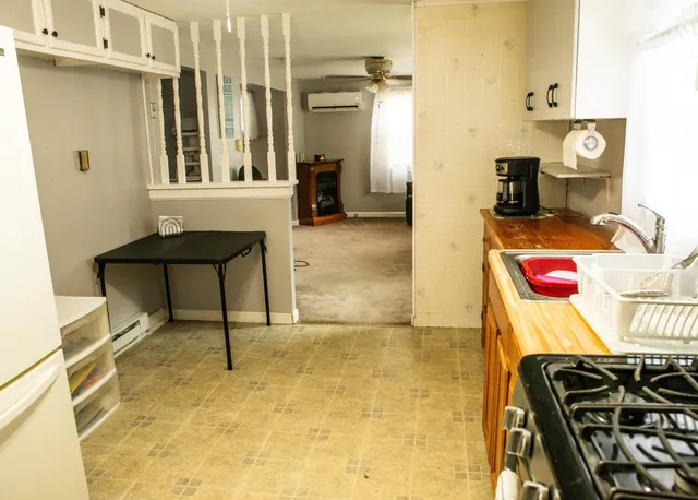 a kitchen with stainless steel appliances a stove a sink and a refrigerator