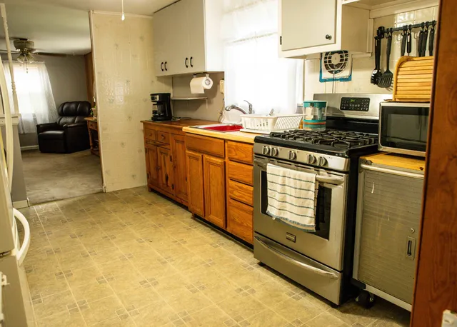 an empty room with wooden floor and window