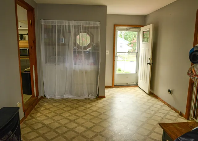a room with gym equipment and a rug