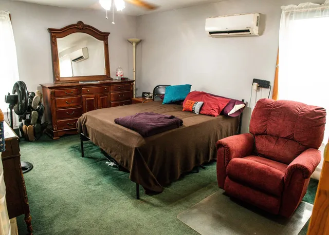 a bedroom with a bed and a window