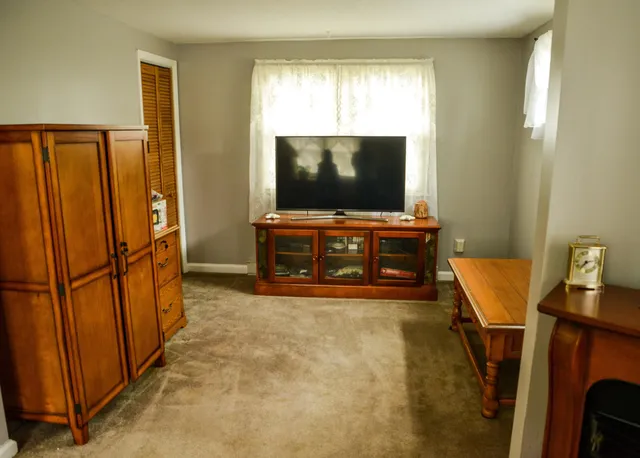 a view of a livingroom with furniture and a window