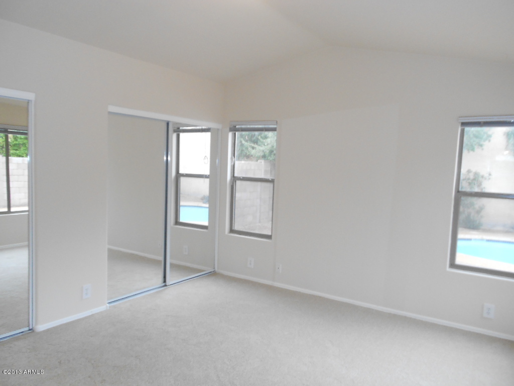 3918 East Agave Road Phoenix, AZ 85044 - Photo 7 of 14 an empty room with windows
