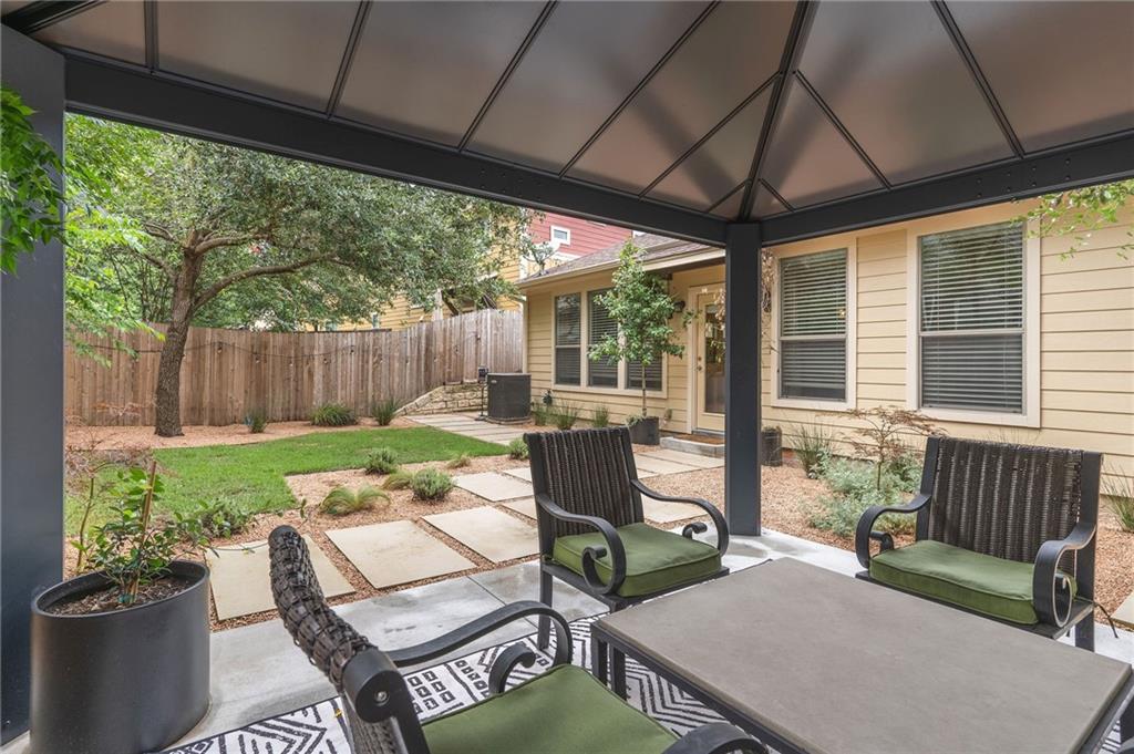 6708 Menchaca Road, Unit 14 Austin, TX 78745 - Photo 3 of 22 Covered patio featuring a metal framed roof structure and a concrete slab