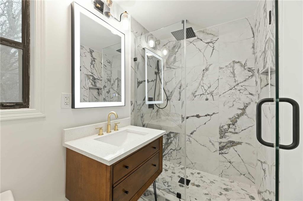 1487 Springwood Drive Southeast, Unit A Smyrna, GA 30080 - Photo 11 of 19 a bathroom with a sink vanity and shower