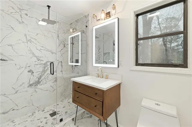 a bathroom with a sink a mirror and a shower