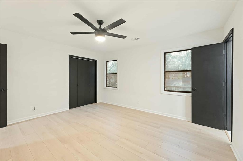 1487 Springwood Drive Southeast, Unit A Smyrna, GA 30080 - Photo 16 of 19 a view of an empty room with wooden floor and a window