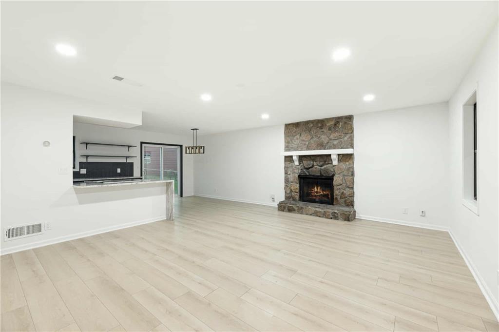 1487 Springwood Drive Southeast, Unit A Smyrna, GA 30080 - Photo 2 of 19 a view of an empty room with a fireplace and a window