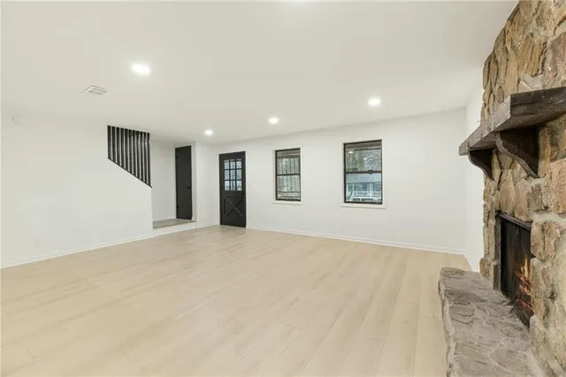 a view of empty room with fireplace and fan