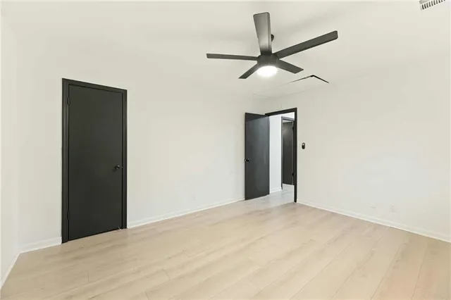 a view of a big room with a ceiling fan