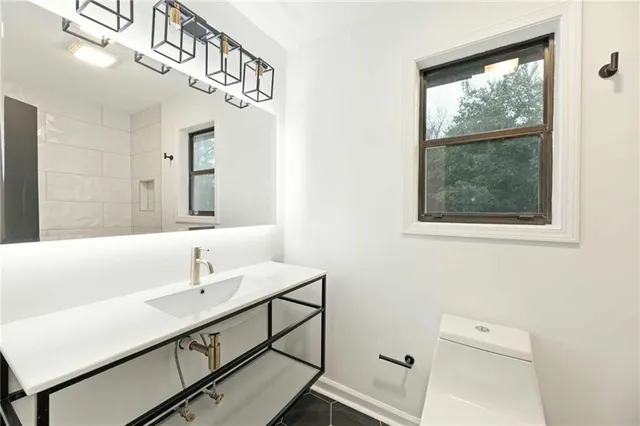 a bathroom with a sink a mirror and a window