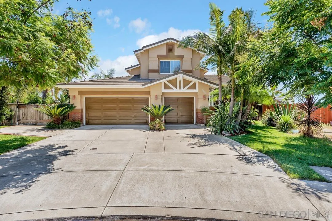 10496 Chaparral Drive Santee, CA 92071 - Photo 1 of 73 a front view of a house with a yard and a garage