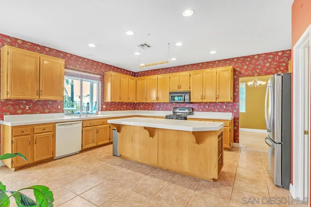 10496 Chaparral Drive Santee, CA 92071 - Photo 16 of 73 a view of a kitchen with granite countertop a sink and a refrigerator