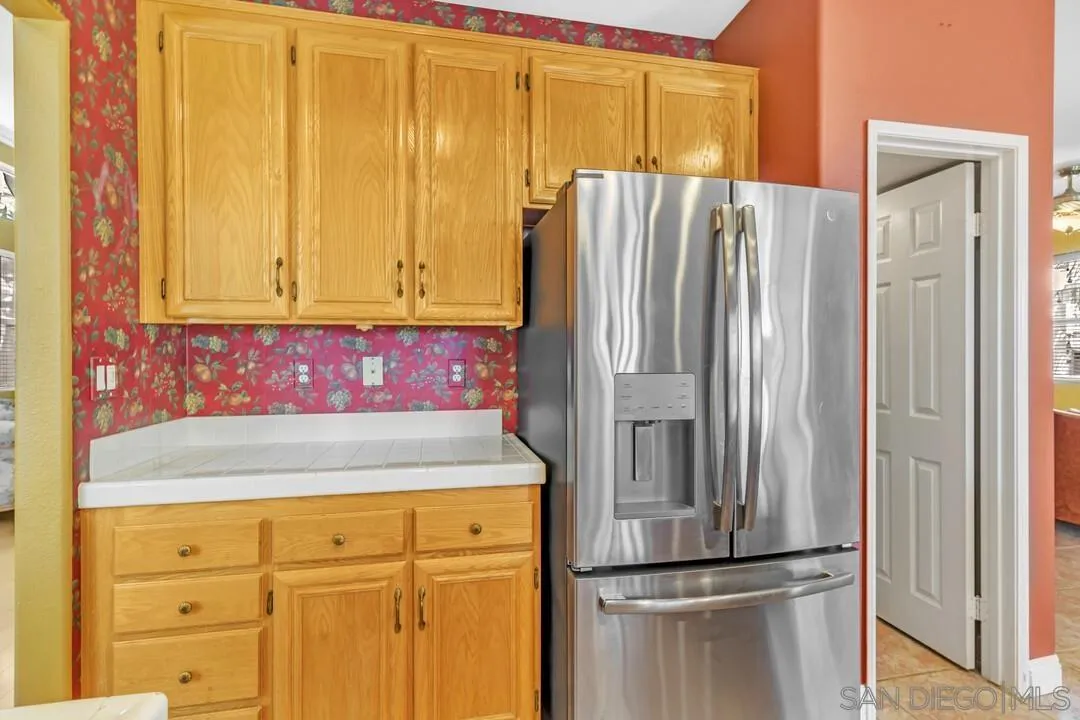 10496 Chaparral Drive Santee, CA 92071 - Photo 19 of 73 a kitchen with a refrigerator and window