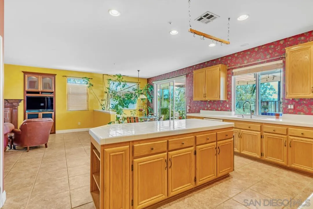 10496 Chaparral Drive Santee, CA 92071 - Photo 20 of 73 a kitchen with sink cabinets and wooden floor