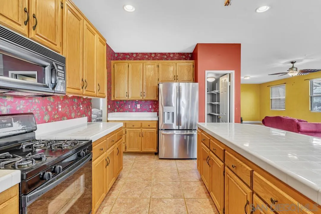 10496 Chaparral Drive Santee, CA 92071 - Photo 23 of 73 a kitchen with a sink stove and refrigerator