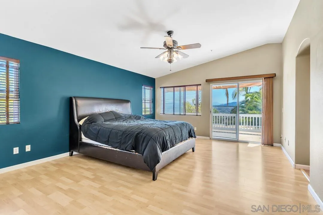10496 Chaparral Drive Santee, CA 92071 - Photo 26 of 73 a spacious bedroom with a bed and large window