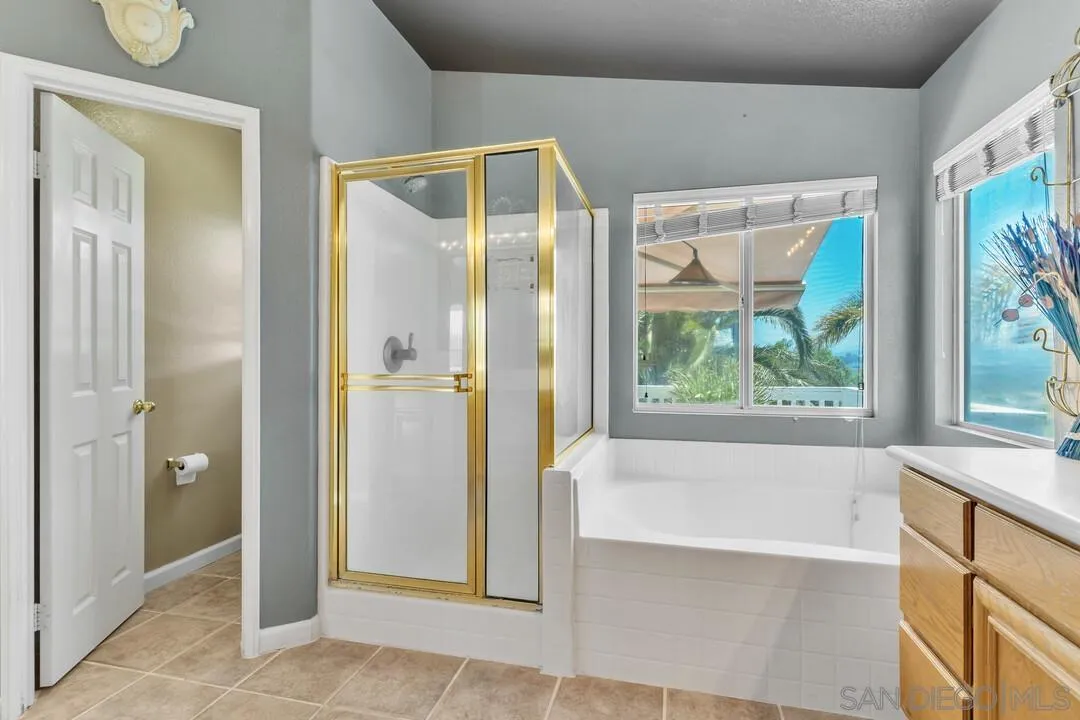 10496 Chaparral Drive Santee, CA 92071 - Photo 36 of 73 a bathroom with a bathtub and a shower